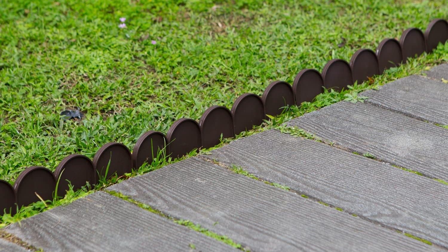 Semi-circular Evelyne fencing drawing a clean line along a garden path