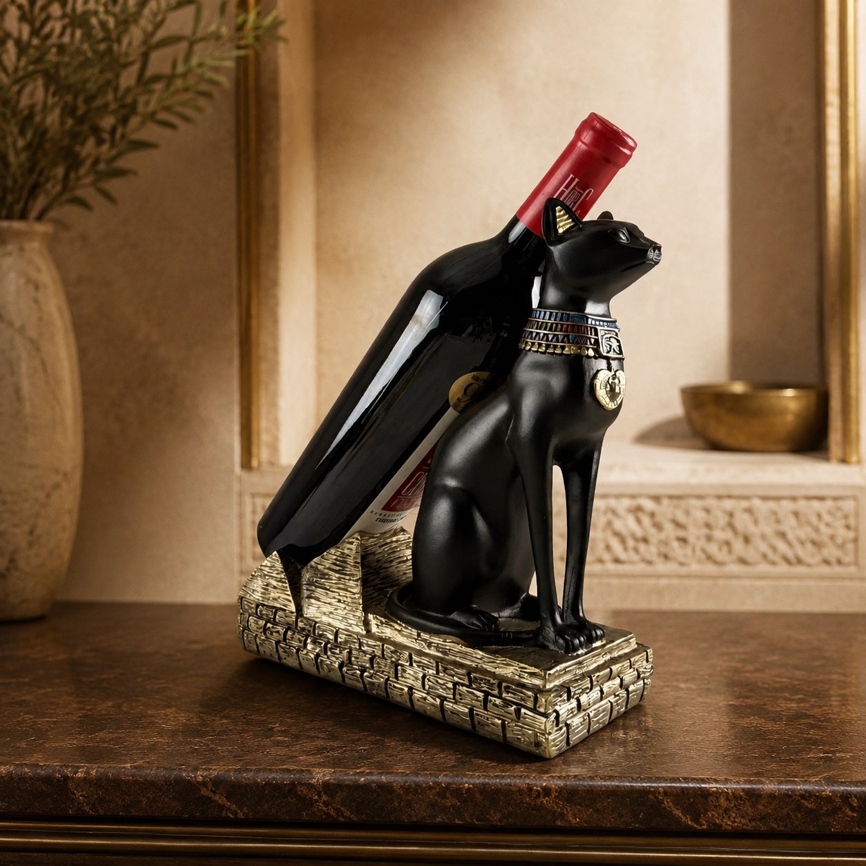 Large Egyptian cat wine bottle holder with red wine bottle on a console table